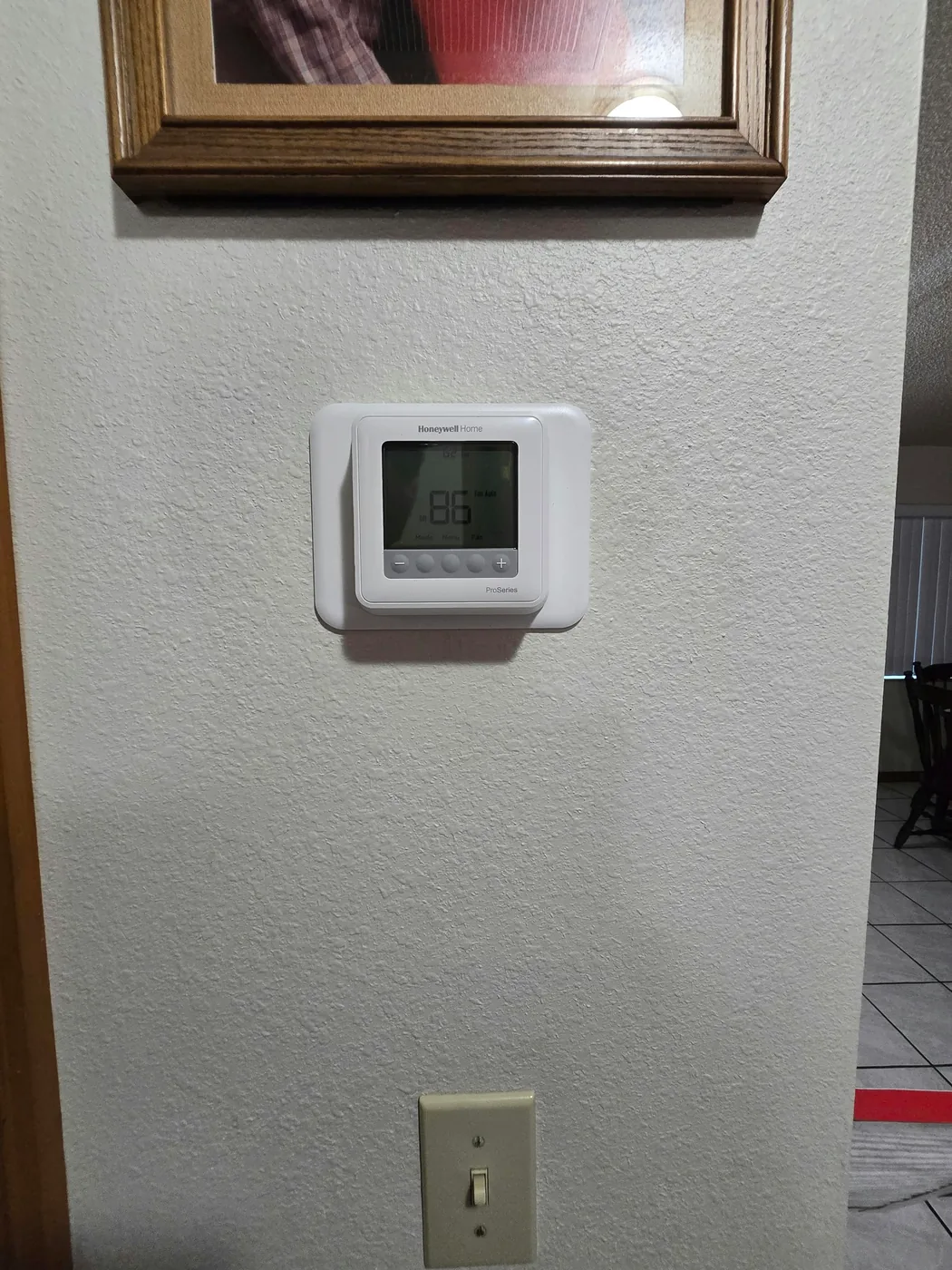 Honeywell ProSeries thermostat installed on a wall
